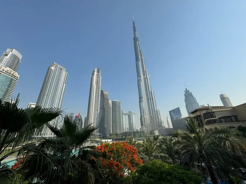 Burj Khalifa and the Downtown Dubai skyline seen through palm trees