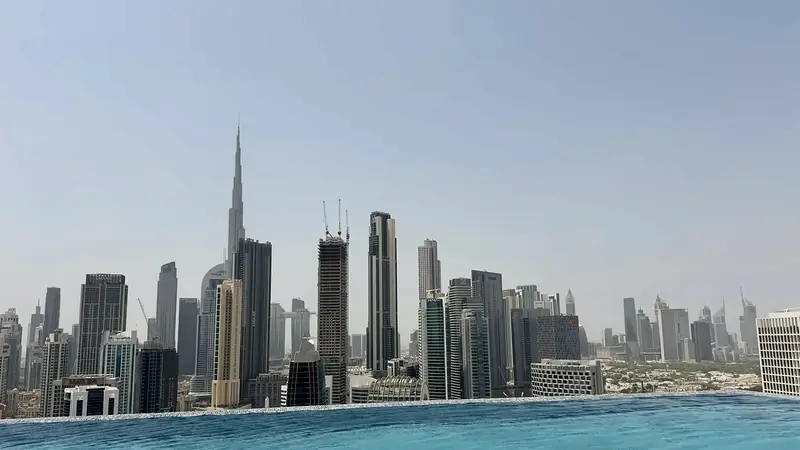 An infinity pool with the Business Bay and Downtown Dubai skyline beyond